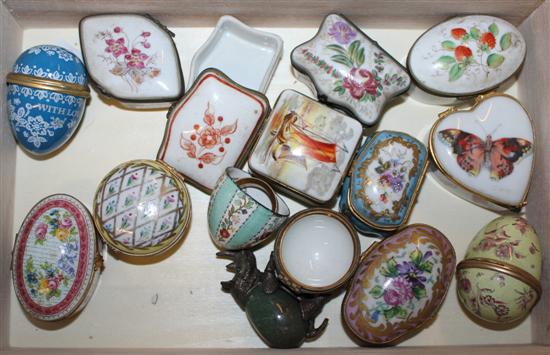 A collection of enamel eggs and porcelain trinket boxes